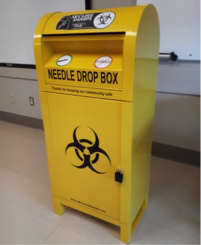 Health unit installing containers for safe needle disposal